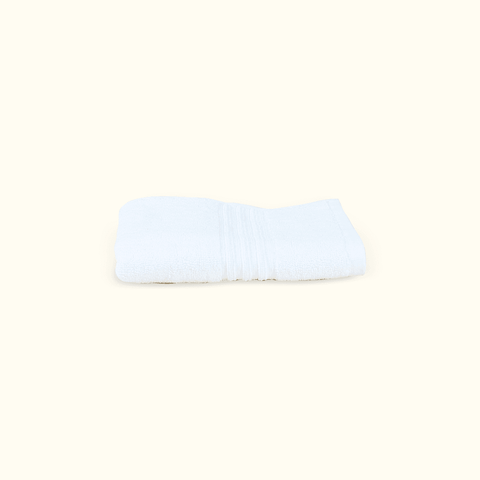Kompakt gefaltetes weißes Handtuch aus dem Premium Luxushotel-Handtücher 4er Set für stilvolle Badezimmer und Hotelkomfort zuhause.